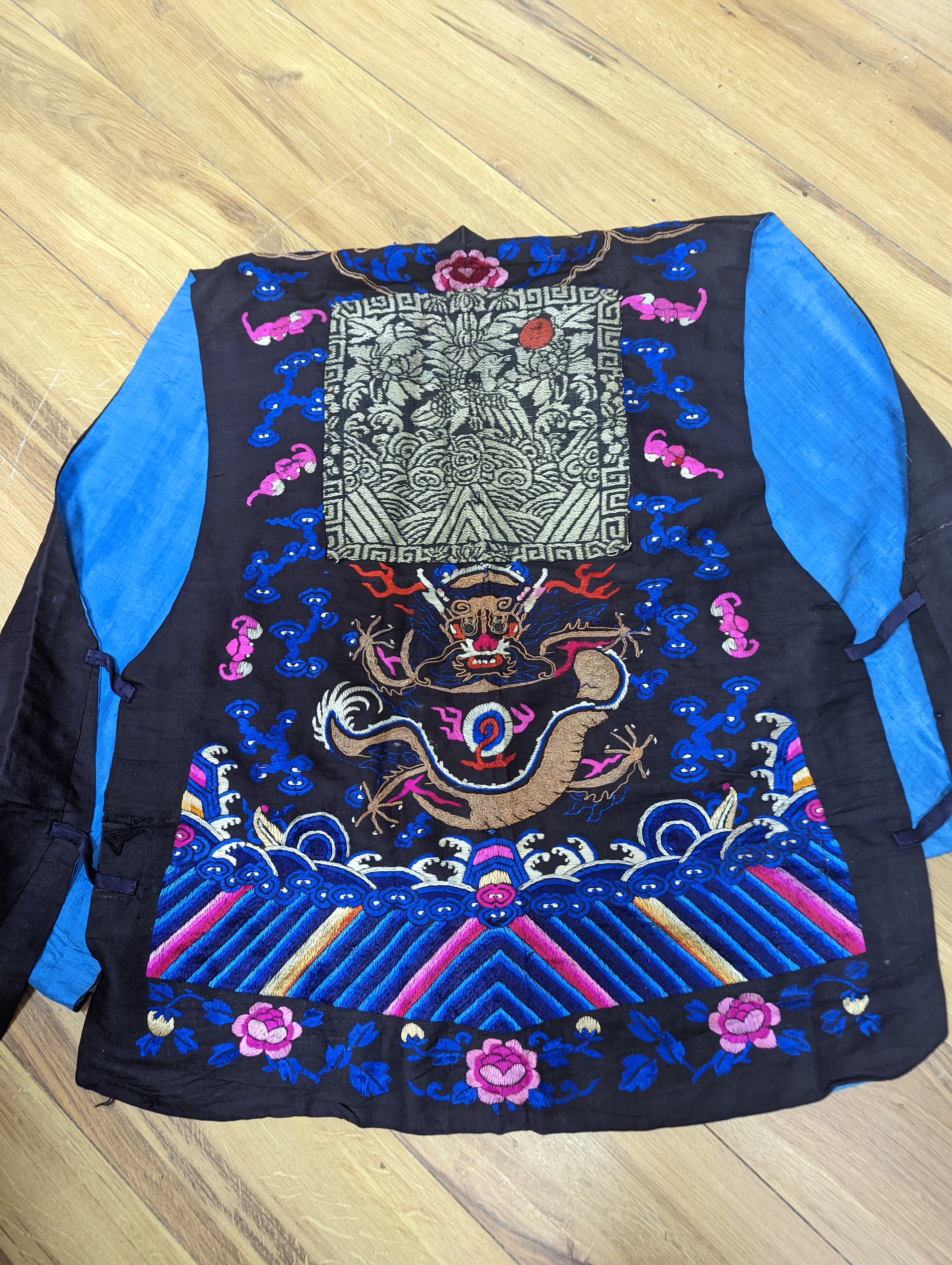 A 1920's Chinese dragon embroidered waistcoat, a cream silk drawn thread dress and a silk crepe black and patterned reversible kimono (3 items).